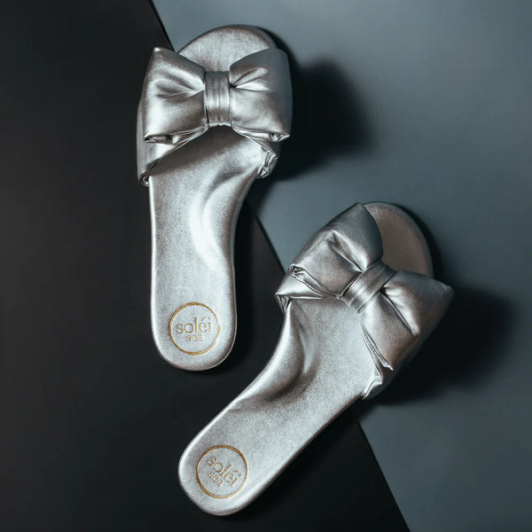 Silver Rafie flip flops with big bow.