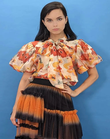 Orange print ruffled short sleeve top.  Bow.