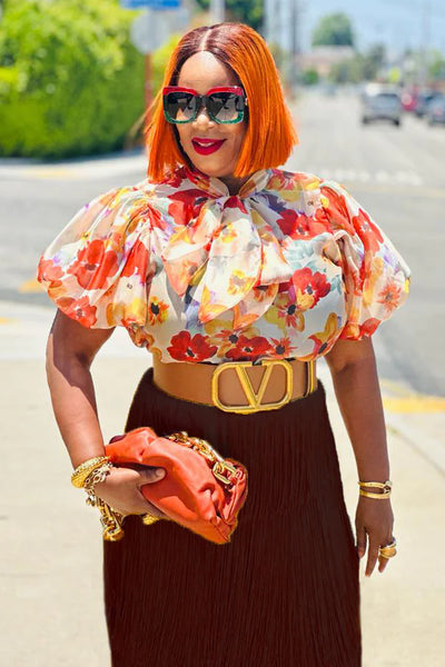 Orange print ruffled short sleeve top.  Bow.