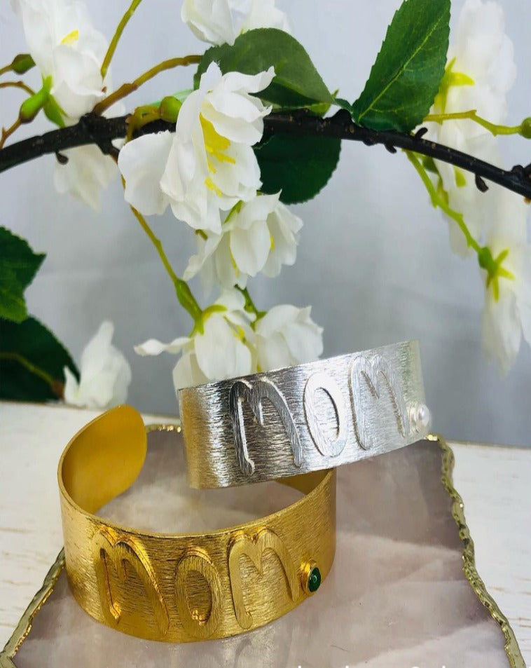 Gold engraved cuff . MOM